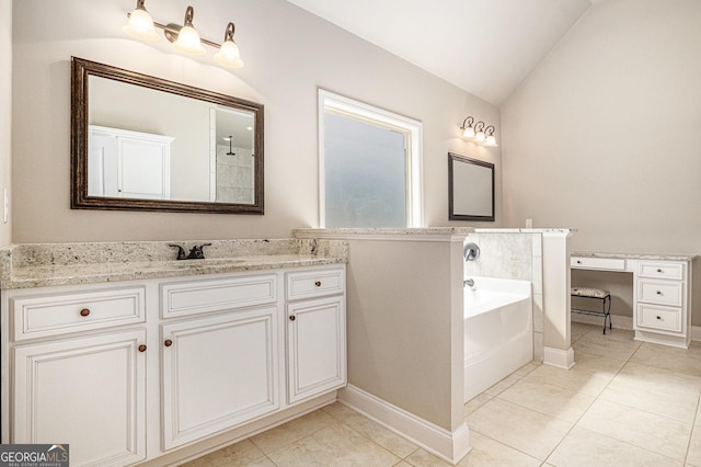 full bathroom featuring vanity, tile patterned floors, vaulted ceiling, baseboards, and a garden tub
