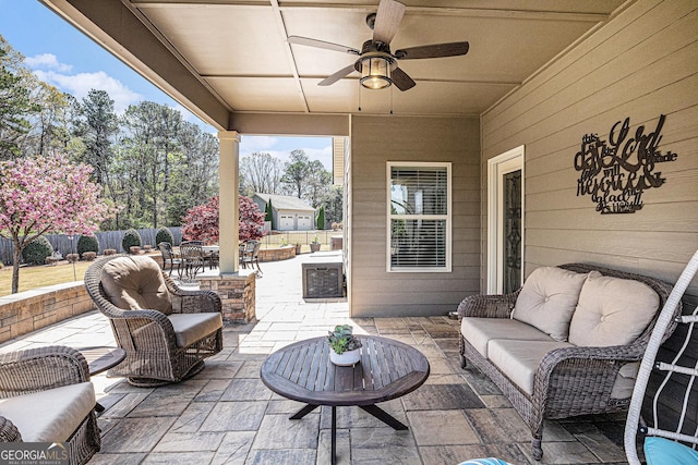 view of patio / terrace featuring an outdoor living space, a ceiling fan, and fence