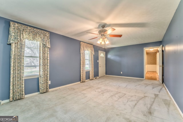 interior space featuring baseboards, carpet flooring, and ceiling fan
