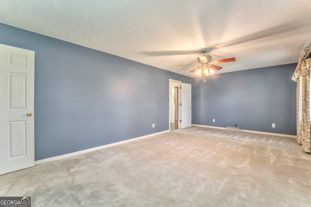 unfurnished room featuring carpet flooring, a ceiling fan, and baseboards
