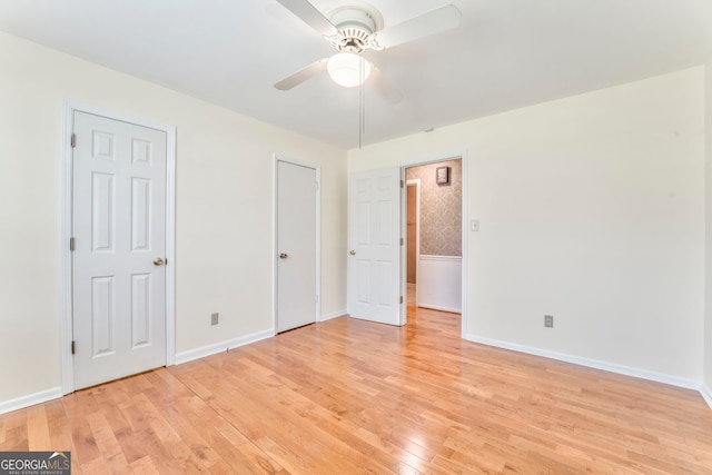 unfurnished bedroom with baseboards, a ceiling fan, and light wood-type flooring