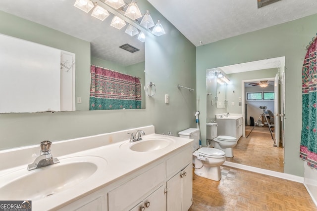full bath with visible vents, toilet, a sink, and a textured ceiling