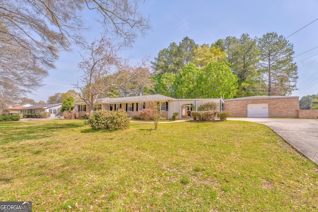 single story home featuring a front lawn, a garage, and concrete driveway