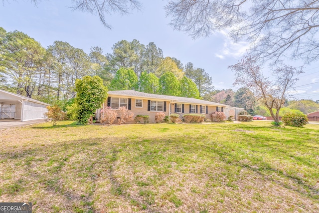 single story home with a front yard and a carport