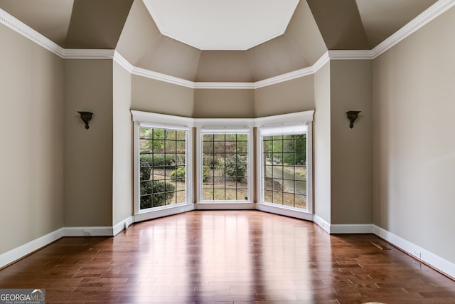 spare room with baseboards, wood finished floors, and a healthy amount of sunlight