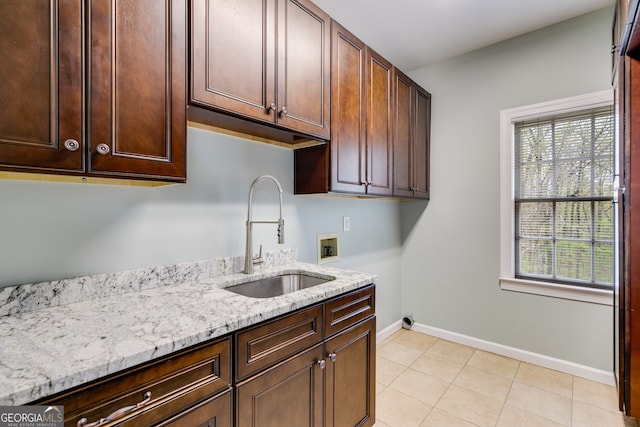 laundry area featuring a healthy amount of sunlight, a sink, hookup for a washing machine, and cabinet space
