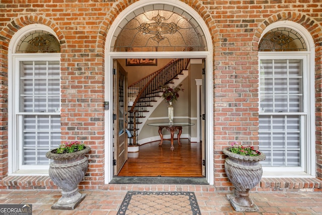 entrance to property featuring brick siding