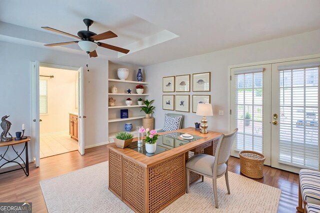 bedroom featuring french doors, baseboards, wood finished floors, access to outside, and ensuite bath