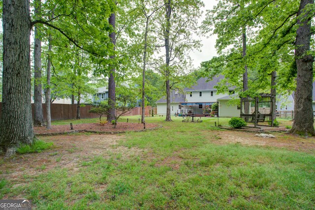view of yard with fence and a pergola