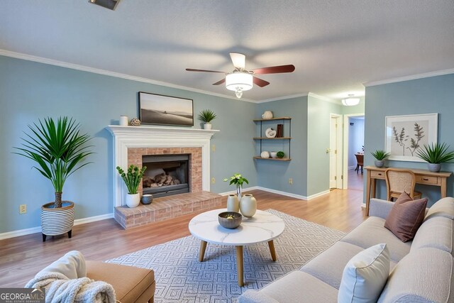 living room featuring baseboards, a ceiling fan, wood finished floors, and ornamental molding