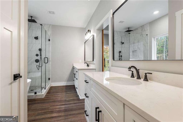 119 Acerose Dr, Jasper, GA 30143 - bathroom featuring a shower stall, two vanities, and wood finished floors