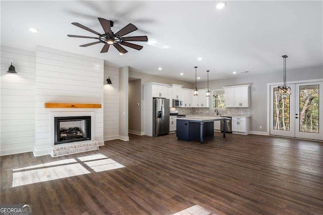 119 Acerose Dr, Jasper, GA 30143 - kitchen with appliances with stainless steel finishes, open floor plan, white cabinets, ceiling fan, and a center island