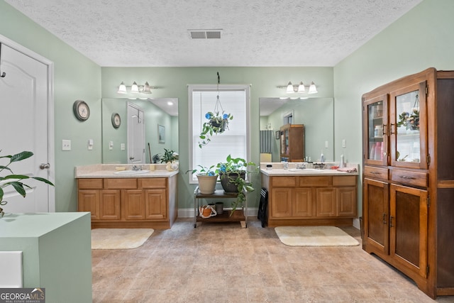 575 Chuli Rd, Locust Grove, GA 30248 - bathroom with two vanities and a textured ceiling