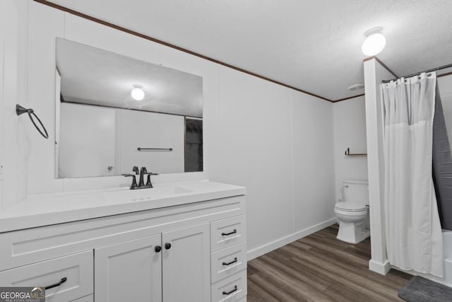 138 Forest Hill Dr, Eatonton, GA 31024 - bathroom featuring toilet, vanity, a textured ceiling, and wood finished floors