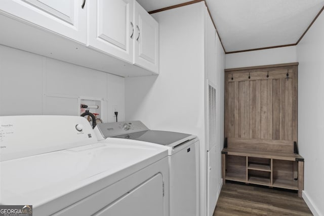 138 Forest Hill Dr, Eatonton, GA 31024 - washroom featuring washing machine and clothes dryer, cabinet space, ornamental molding, and dark wood-type flooring