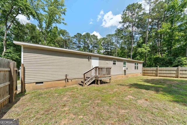 138 Forest Hill Dr, Eatonton, GA 31024 - back of property with a fenced backyard, crawl space, and a yard