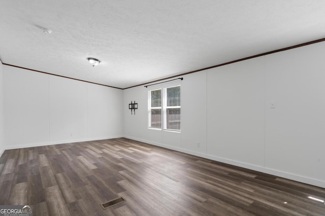 138 Forest Hill Dr, Eatonton, GA 31024 - unfurnished room featuring wood finished floors, crown molding, a textured ceiling, and visible vents