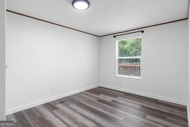 138 Forest Hill Dr, Eatonton, GA 31024 - unfurnished room with ornamental molding, baseboards, a textured ceiling, visible vents, and wood finished floors