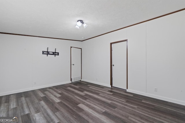 138 Forest Hill Dr, Eatonton, GA 31024 - spare room with a textured ceiling, baseboards, ornamental molding, and dark wood-style flooring