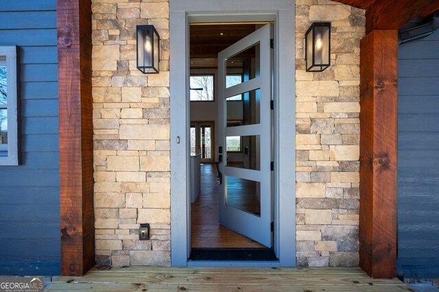 doorway to property with stone siding