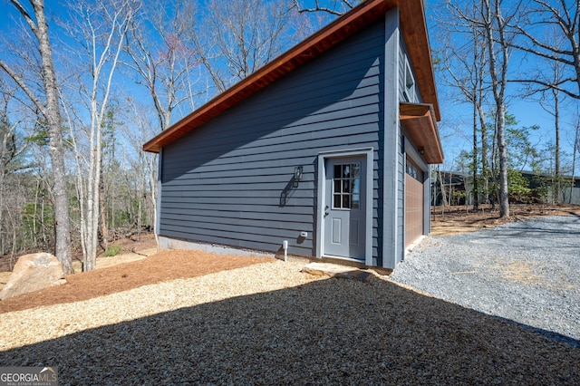 exterior space with an outbuilding and a garage