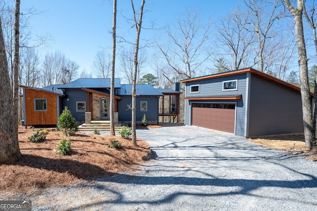 view of front of home featuring a garage, driveway, and an outdoor structure