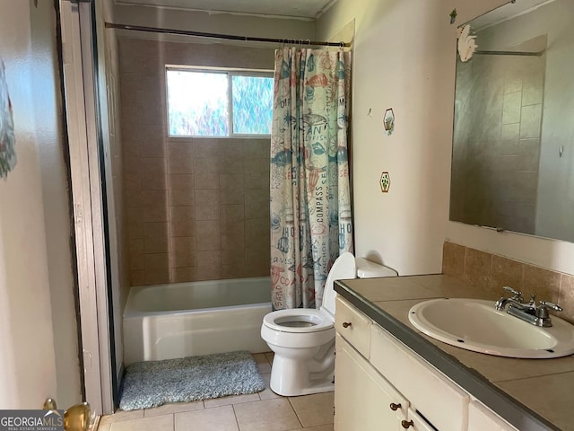 bathroom with tile patterned floors, toilet, vanity, and shower / bath combo with shower curtain