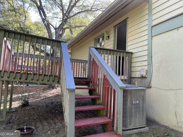 wooden terrace with stairs and central AC unit
