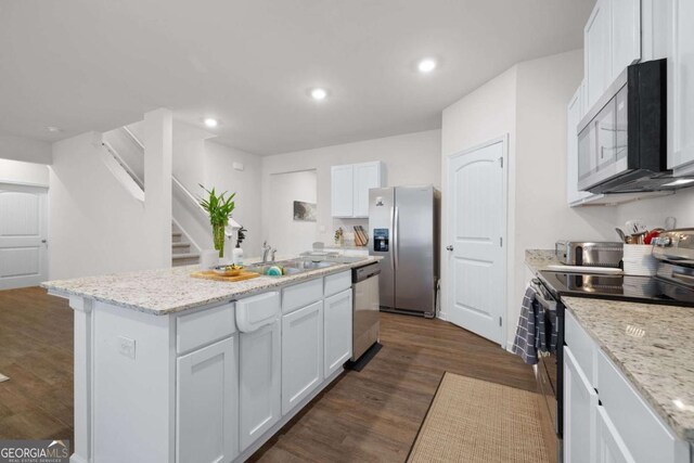 138 Brode Ln, Pendergrass, GA 30567 - kitchen with stainless steel appliances, recessed lighting, an island with sink, and white cabinetry