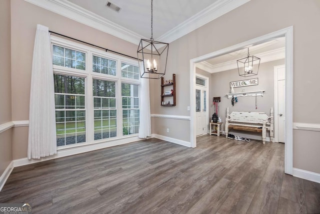 unfurnished dining area featuring a notable chandelier, baseboards, dark wood-style flooring, ornamental molding, and visible vents