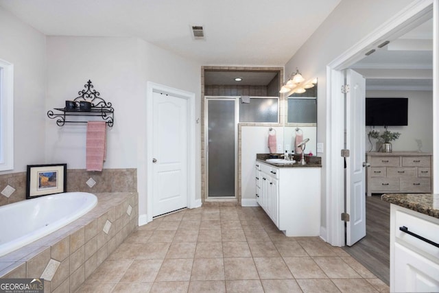 full bathroom with a garden tub, a shower stall, vanity, visible vents, and tile patterned floors