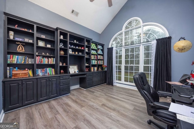 office with light wood-style flooring, high vaulted ceiling, a ceiling fan, and visible vents