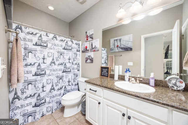 bathroom featuring a shower with curtain, toilet, a textured ceiling, vanity, and tile patterned flooring