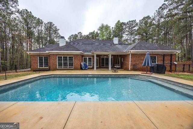 view of swimming pool with a patio area, fence, and a fenced in pool