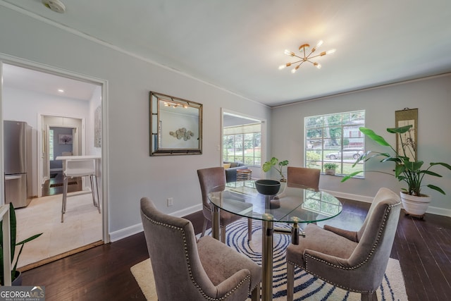 dining area featuring baseboards, a notable chandelier, and wood-type flooring