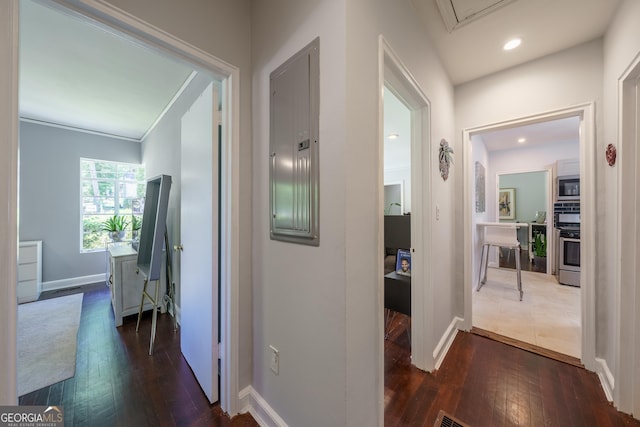 hallway featuring dark wood-style flooring, electric panel, baseboards, recessed lighting, and attic access