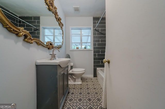 bathroom with baseboards, visible vents, toilet, and vanity