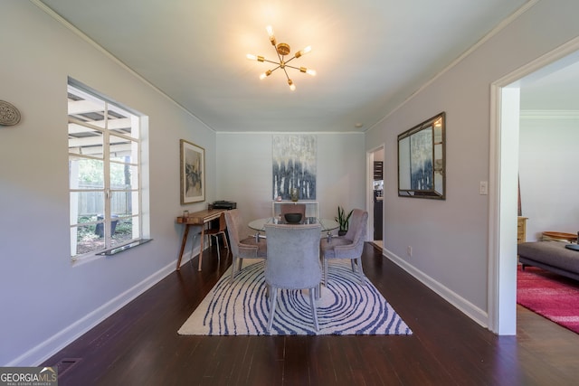 dining room featuring baseboards, wood finished floors, a chandelier, and crown molding
