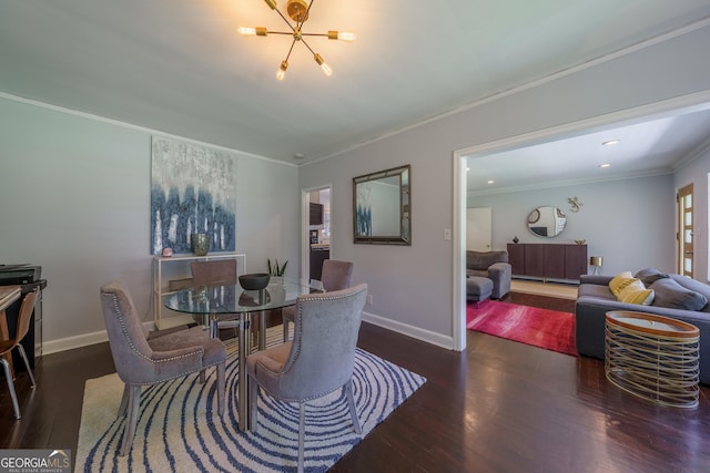 dining area featuring an inviting chandelier, ornamental molding, baseboards, and wood finished floors