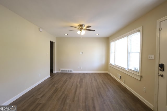 empty room with baseboards, visible vents, and a ceiling fan
