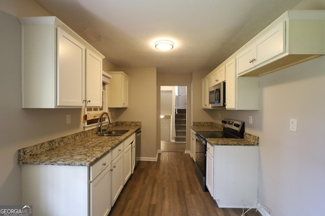 4044 Lindsey Dr, Decatur, GA 30035 - kitchen featuring stone counters, a sink, stainless steel appliances, white cabinets, and dark wood-style flooring