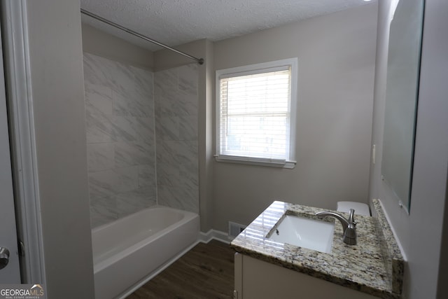 4044 Lindsey Dr, Decatur, GA 30035 - bathroom featuring bathtub / shower combination, vanity, wood finished floors, a textured ceiling, and visible vents
