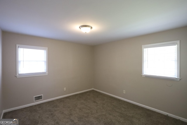 4044 Lindsey Dr, Decatur, GA 30035 - unfurnished room featuring baseboards, visible vents, and dark colored carpet