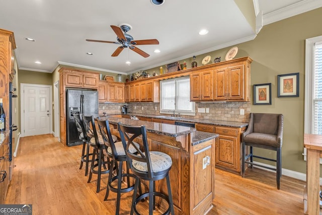 2323 Council Ln, Buford, GA 30519 - kitchen featuring black refrigerator with ice dispenser, ceiling fan, brown cabinets, light wood-style flooring, and recessed lighting