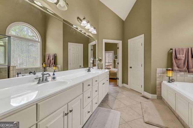 2323 Council Ln, Buford, GA 30519 - bathroom featuring a bath, double vanity, vaulted ceiling, tile patterned floors, and connected bathroom