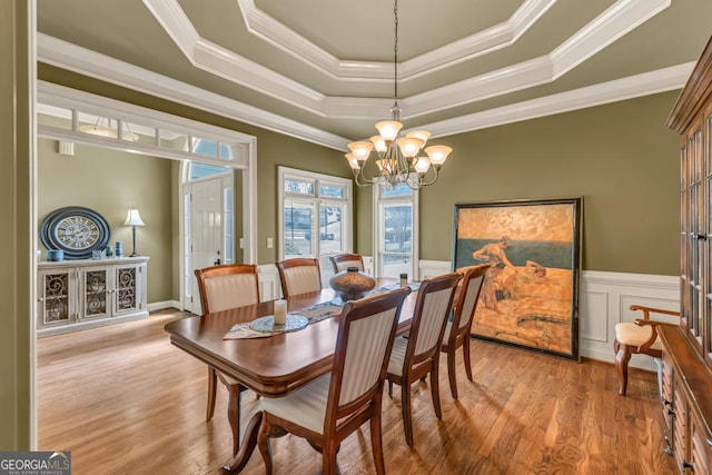 2323 Council Ln, Buford, GA 30519 - dining area featuring a tray ceiling, crown molding, a chandelier, wood finished floors, and a wainscoted wall
