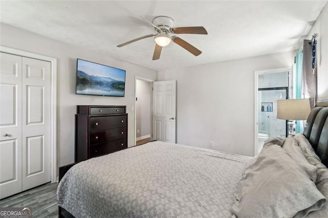 bedroom featuring a ceiling fan, ensuite bath, a closet, and wood finished floors