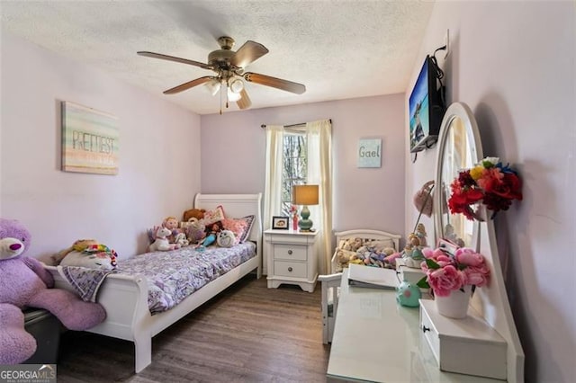bedroom featuring wood finished floors, ceiling fan, and a textured ceiling
