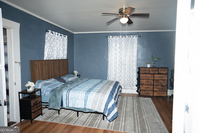 bedroom featuring crown molding and wood finished floors