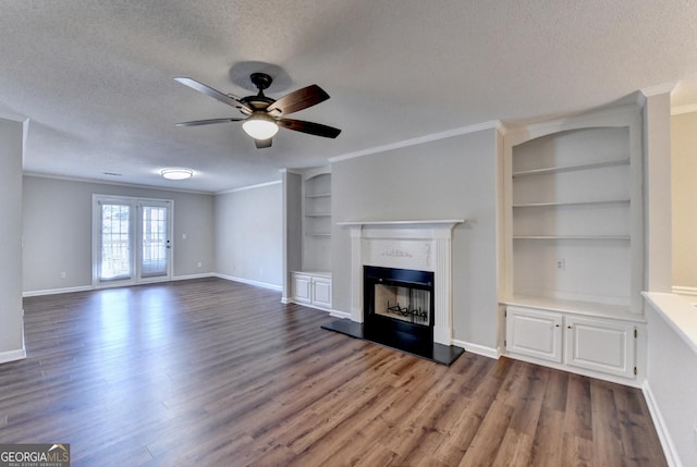 unfurnished living room with a textured ceiling, wood finished floors, and ceiling fan